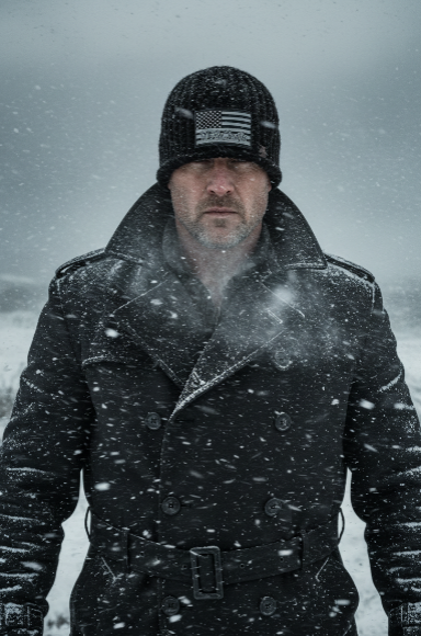 Home Front™ No. 5 handmade black Big Noggin Skull Hugger™ winter beanie with Flat Head Crown™ and monochrome We the People American flag patch, shown worn in snow.