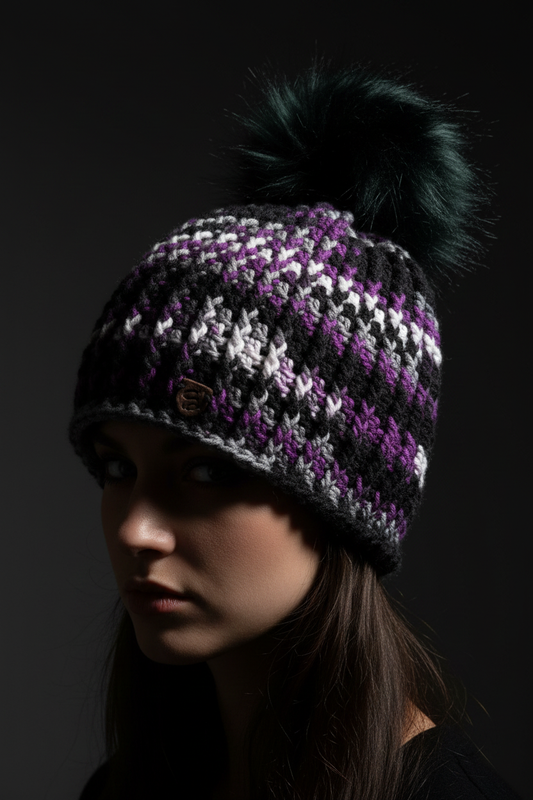 After Dark™ Classic Rib™ handmade crochet beanie in black, purple, and silver with oversized dark pom On Model Head 