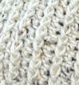 Close up of Fireside Oat ribbed crochet beanie showing dense winter-ready stitch detail
