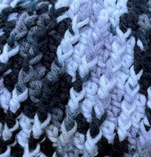 snow leopard crochet beanie close up ribbed stitch detail vertical texture thick winter hat construction
