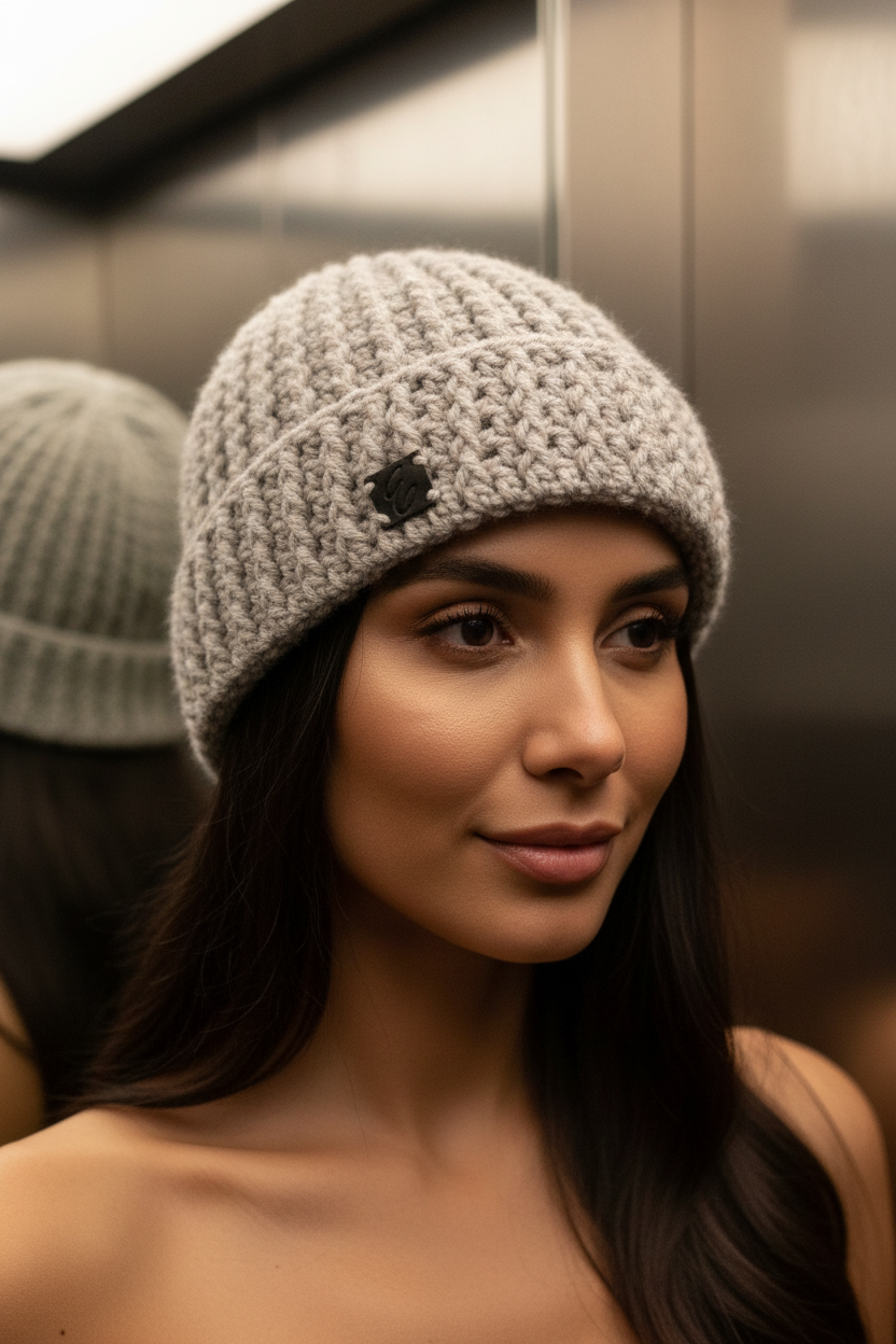 Woman wearing a gray crochet beanie in an elevator