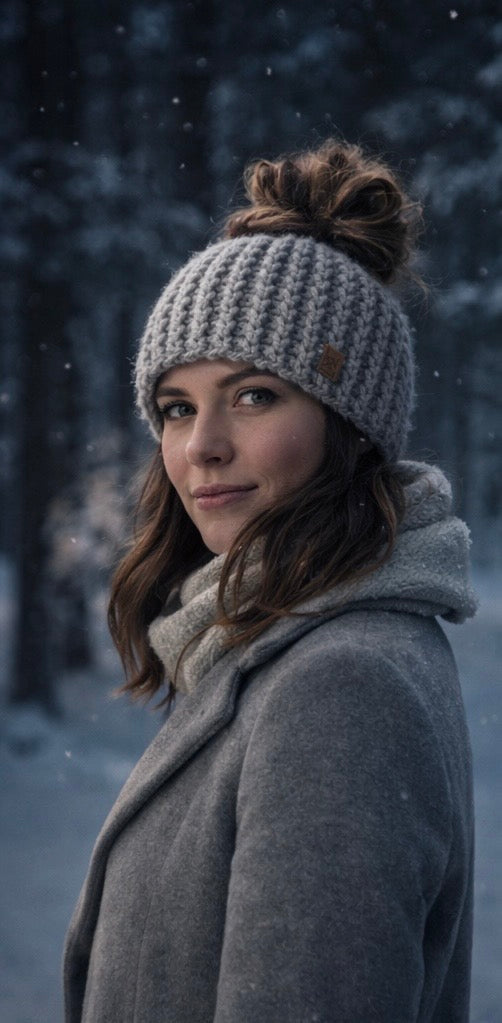 Silver Passage light gray ribbed open-tail messy bun crochet beanie worn outdoors in winter setting for cold climate wear