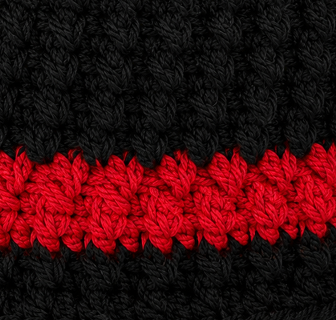 Close-up of black and red crochet stitch detail on Thin Red Line OpenTail™ beanie