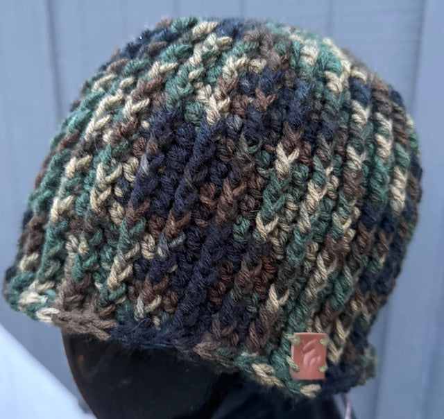 Multicolored crochet hat on a mannequin against a light blue background